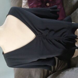 Beautiful poly, v-neck, rouged front, flair sleeve, ruffle bottom ladies blouse.